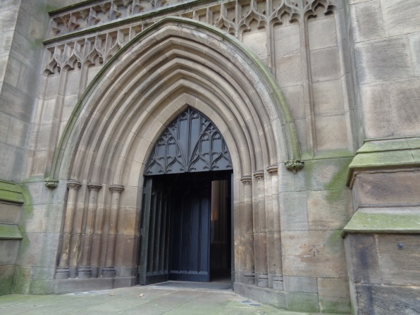 The main door at Leeds Minster with the bench mark on its right (taken Nov 11 2015).