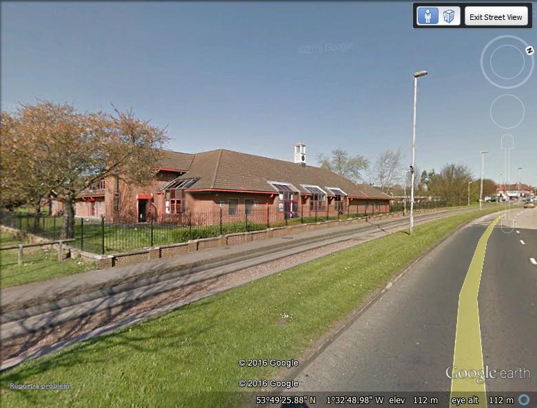 A Google Street View of Potternewton Centre by the guided bus way on Scott Hall Road.