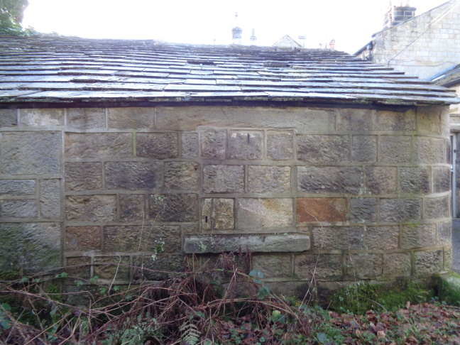 OuthouseWallWithSlotByTrackOffBackChurchLaneTo AdelChurchLeedsDec252020..jpg