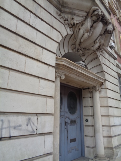 Doorway on the North Street  frontage of the old Dispensary with the nice carving and the old door bell push button (taken April 1 2016).