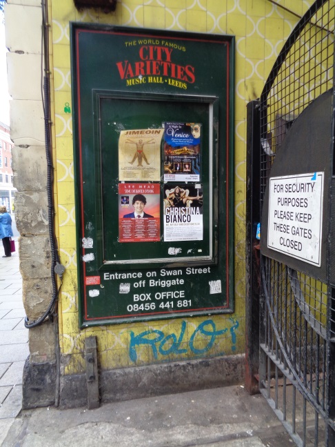 Location of an eroded Bench Mark on the Horse &amp; Trumpet pub, The Headrow, Leeds, with an old entry/exit to the City Varieties on the right (taken July 5 2016).